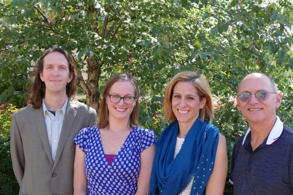 Four PEN faculty smiling together.