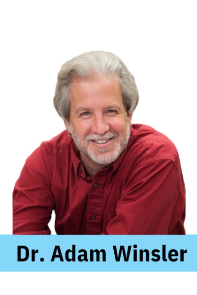 ID: A caucasian-presenting man with short gray hair and gray mustache and beard is smiling. 
